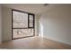 Bright bedroom featuring hardwood floors and a large window showcasing desert landscaping at 5000 N Camelback Ridge Rd # 109, Scottsdale, AZ 85251