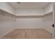 Walk-in closet with minimalist design featuring ample storage space and streamlined shelving at 5000 N Camelback Ridge Rd # 109, Scottsdale, AZ 85251