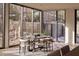 Dining area with large windows offering natural light and views of the professionally landscaped yard at 5000 N Camelback Ridge Rd # 109, Scottsdale, AZ 85251