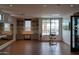 Well-equipped gym with a barre, weight machine, and a wall of mirrors at 5000 N Camelback Ridge Rd # 109, Scottsdale, AZ 85251