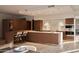 Modern kitchen featuring premium appliances, island with bar seating, and sleek cabinetry at 5000 N Camelback Ridge Rd # 109, Scottsdale, AZ 85251