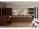 Modern kitchen featuring stainless steel appliances, stone countertops and island with seating at 5000 N Camelback Ridge Rd # 109, Scottsdale, AZ 85251