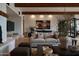 Cozy living room with wood beams, neutral furniture, and decorative plants at 5000 N Camelback Ridge Rd # 109, Scottsdale, AZ 85251