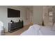 Serene bedroom with a modern dresser, plush bedding, and access to a private bathroom at 5000 N Camelback Ridge Rd # 109, Scottsdale, AZ 85251