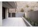 Outdoor patio with stone hillside and desert landscaping along the back walls at 5000 N Camelback Ridge Rd # 109, Scottsdale, AZ 85251
