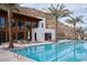 Stunning pool area with palm trees, modern architecture, and lounge chairs, perfect for relaxation at 5000 N Camelback Ridge Rd # 109, Scottsdale, AZ 85251