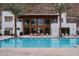 Luxurious pool and sundeck with palm trees and modern architectural features at 5000 N Camelback Ridge Rd # 109, Scottsdale, AZ 85251