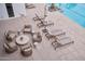 Chic outdoor patio with comfortable seating and lounge chairs next to a sparkling pool at 5000 N Camelback Ridge Rd # 109, Scottsdale, AZ 85251