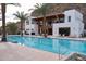Upscale pool with palm trees and modern building facade, complemented by comfortable lounge seating at 5000 N Camelback Ridge Rd # 109, Scottsdale, AZ 85251