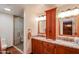 Bathroom with a dual sink vanity, granite countertop, and custom tiled shower at 5306 N 20Th St, Phoenix, AZ 85016