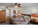 Bedroom with a ceiling fan, an exercise bike, and a bed with a patterned quilt at 5306 N 20Th St, Phoenix, AZ 85016