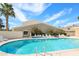 Community pool with clear blue water surrounded by lounge chairs, palm trees, and well-kept grounds at 5306 N 20Th St, Phoenix, AZ 85016