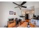 Cozy dining area with a ceiling fan and a view into the kitchen featuring modern appliances and wooden floors at 5306 N 20Th St, Phoenix, AZ 85016