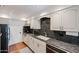 Modern kitchen with stainless steel appliances, white cabinets, granite countertops, and tile flooring at 5306 N 20Th St, Phoenix, AZ 85016