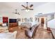 An open-concept living room featuring vaulted ceiling, ceiling fans, and wood look tile floors at 5306 N 20Th St, Phoenix, AZ 85016