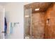 Tiled shower stall with glass door and built-in shelves for toiletries at 5306 N 20Th St, Phoenix, AZ 85016
