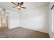 This bedroom has carpeted floors, a ceiling fan, and hallway access at 5450 E Deer Valley Dr # 4015, Phoenix, AZ 85054