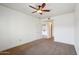 Neutral bedroom with carpet, ceiling fan, white walls, and an open door leading to other rooms at 5450 E Deer Valley Dr # 4015, Phoenix, AZ 85054