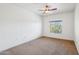This bedroom has carpeted floors, a ceiling fan, and a window at 5450 E Deer Valley Dr # 4015, Phoenix, AZ 85054