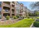 Well-maintained building exterior with green landscaping and beautiful stone facade at 5450 E Deer Valley Dr # 4015, Phoenix, AZ 85054