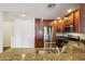 Charming kitchen featuring stainless steel appliances, granite countertops, and rich wood cabinetry at 5450 E Deer Valley Dr # 4015, Phoenix, AZ 85054