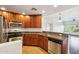 Open kitchen design featuring granite countertops, stainless steel appliances, and dark wood cabinets at 5450 E Deer Valley Dr # 4015, Phoenix, AZ 85054