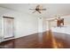 Bright living room featuring wood floors, ceiling fan, and sliding door to balcony at 5450 E Deer Valley Dr # 4015, Phoenix, AZ 85054