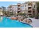 Resort-style pool with a rock waterfall feature and comfortable seating, surrounded by lush landscaping at 5450 E Deer Valley Dr # 4015, Phoenix, AZ 85054