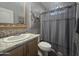 Clean bathroom with single sink vanity, shower/tub combo, and toilet at 650 N Hawes Rd # 2709, Mesa, AZ 85207