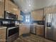 Modern kitchen with stainless steel appliances and wood cabinets at 650 N Hawes Rd # 2709, Mesa, AZ 85207