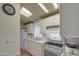 Bright kitchen features white cabinets, modern appliances, and skylights at 7750 E Broadway Rd # 309, Mesa, AZ 85208