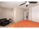 Bright bedroom with a comfy chair and ceiling fan at 8454 E Keats Ave, Mesa, AZ 85209