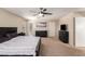 Primary bedroom with a large bed, ceiling fan, and plenty of dresser space at 8454 E Keats Ave, Mesa, AZ 85209