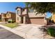 Two-story house with a two-car garage and a tree-lined street at 8454 E Keats Ave, Mesa, AZ 85209
