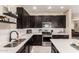 Modern kitchen with dark cabinetry and stainless steel appliances at 8454 E Keats Ave, Mesa, AZ 85209
