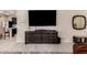 Living room with dark wood entertainment center and large TV at 8454 E Keats Ave, Mesa, AZ 85209