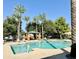 Community pool with palm trees and a covered patio area at 8454 E Keats Ave, Mesa, AZ 85209