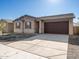 Front view of a new home with a brown garage door at 8643 W Albeniz Pl, Tolleson, AZ 85353