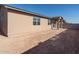 Tan house exterior with covered patio and yard at 8643 W Albeniz Pl, Tolleson, AZ 85353