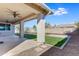 Covered patio, grassy area, and playground in backyard at 9038 W Orchid Ln, Peoria, AZ 85345