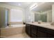 Spa-like bathroom with soaking tub and double vanity at 9038 W Orchid Ln, Peoria, AZ 85345