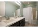Clean bathroom with double vanity, bathtub, and shower at 9038 W Orchid Ln, Peoria, AZ 85345