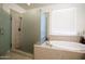 Bathroom with a large walk-in shower and separate tub at 9038 W Orchid Ln, Peoria, AZ 85345