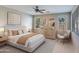 Bright bedroom with a queen-size bed and neutral decor at 9038 W Orchid Ln, Peoria, AZ 85345