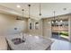 Kitchen island with double sink, granite countertops, and pendant lights at 9038 W Orchid Ln, Peoria, AZ 85345