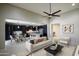 Open living area with kitchen access, modern furniture and decor at 9038 W Orchid Ln, Peoria, AZ 85345