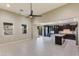 Open concept living room with kitchen and access to backyard at 9038 W Orchid Ln, Peoria, AZ 85345