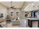 Open living room and kitchen with modern decor and island at 9038 W Orchid Ln, Peoria, AZ 85345