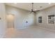 Open living room with tile floors and neutral color palette at 9038 W Orchid Ln, Peoria, AZ 85345