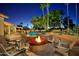 Night view of the backyard pool and fire pit at 9748 E Becker Ln, Scottsdale, AZ 85260